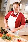 Man chopping vegetables in kitchen