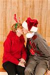 Elderly couple kissing at Christmastime