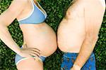 Man and pregnant woman touching bellies