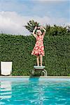 Elderly woman dancing on diving board