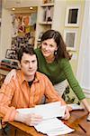 Concerned couple doing paperwork at home
