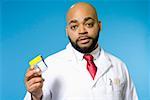 Portrait of male doctor holding container