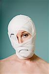 Woman with head wrapped in bandage