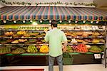 Man selecting produce in supermarket