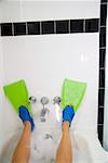 Woman wearing flippers in bathtub