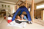 Couple camping in their unfinished living room