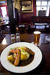 Plate of potatoes and sausages in a pub, Cotswolds, United Kingdom