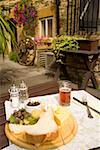 Plate of pub food pinning down map outdoors, Cotswolds, United Kingdom