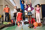 Group of students cheering in hallway