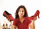 Woman comparing shoes at boutique