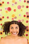 Woman looking up in front of flower background