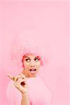 Woman wearing pink wig and pointing