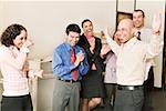 Group of co-workers clapping for businessman