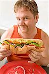 Man holding a big hoagie sandwich