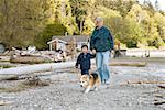 Grandmother and grandson walking on beach