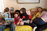 Family reading on sofa