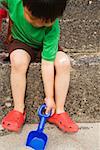 Young boy digging in the sand