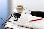 Circled classified ad next to coffee cup and telephone