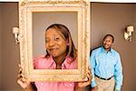 African woman looking through picture frame