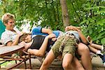 Children laying on mother in lounge chair