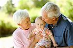 Senior couple holding baby