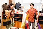 Hispanic couple shopping in clothing store