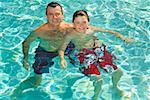 Father and son in swimming pool