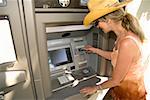 Woman using automatic teller machine