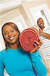 African couple carrying rug