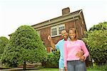 African couple in front of new house