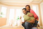 African couple eating take out in new house