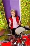 Senior woman playing drums