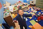Asian boy in messy bedroom