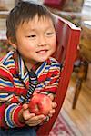 Asian boy holding apple