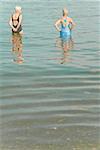 Senior women standing in water