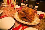Roasted turkey in center of set table