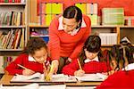 African female teacher helping student