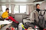 Father and daughter in car with luggage