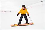 Asian girl riding on sled