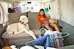 Asian girl sitting in car with dog