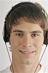 Young male adult;listening to music with earphones
