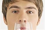 Young male adult smelling a glass of wine