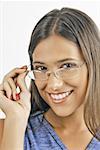 Female young adult looking over eyeglasses