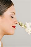 Female young adult smelling a flower