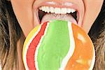 Female adult closeup eating a lollipop