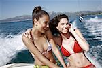 Two female young adults on speedboat