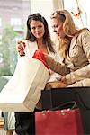 Women Showing Purchases to her Friend