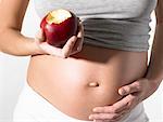 Pregnant woman with an apple