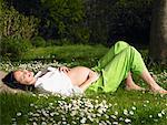 Pregnant woman in the garden, smiling