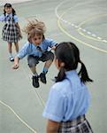 School boy skipping rope